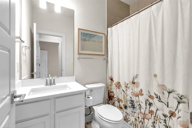 an empty room with ceiling fan and window