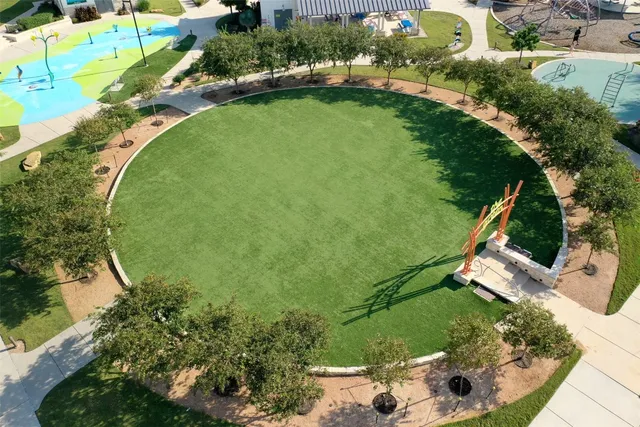 an aerial view of a house with a garden and lake view