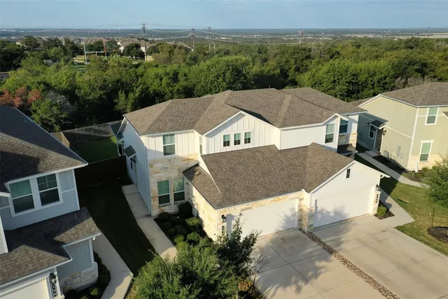 a aerial view of a house next to a yard