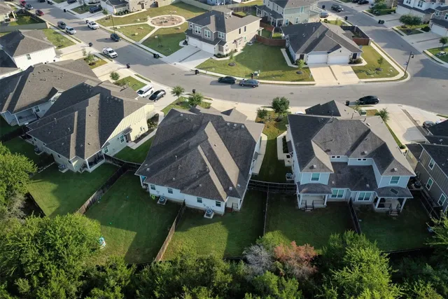 an aerial view of a house with table and chairs