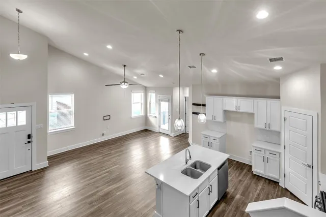a view of kitchen with sink microwave and refrigerator