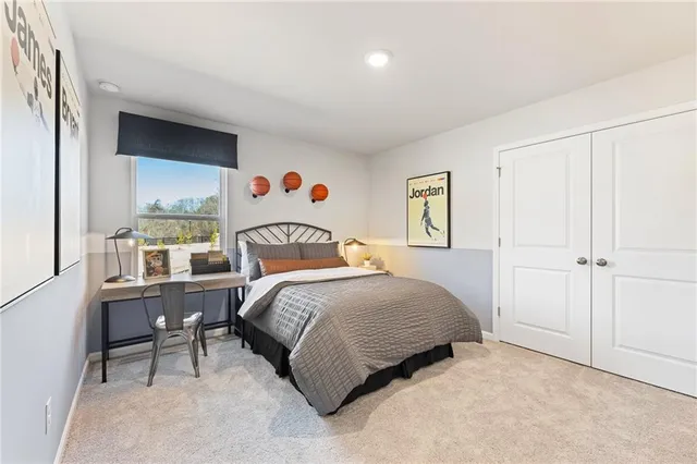 a bedroom with a bed and a painting on the wall