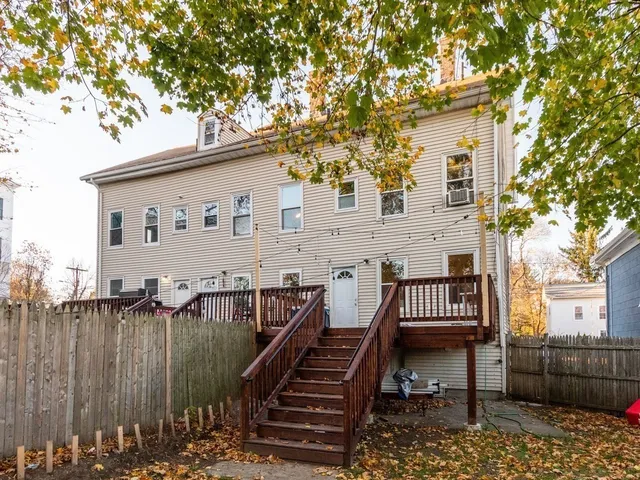a view of a patio with iron fence