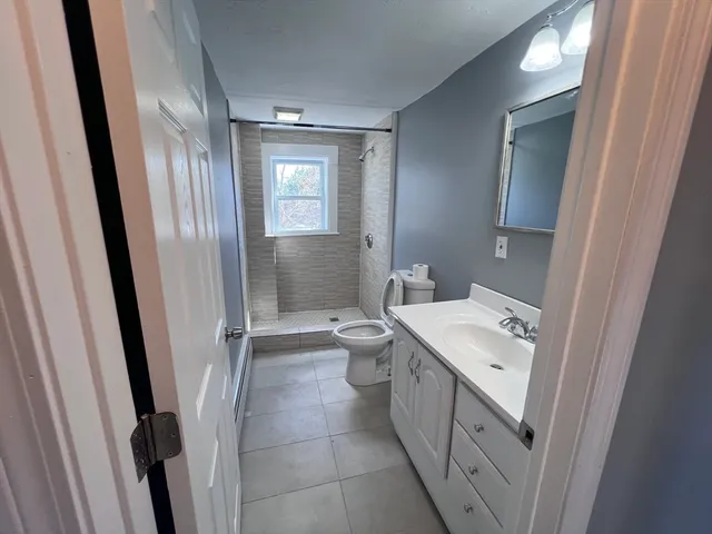 a bathroom with a sink a toilet and a mirror