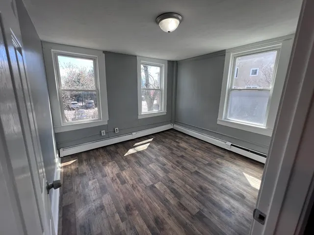 wooden floor in an empty room with a window
