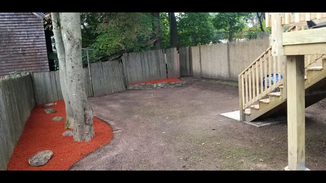 a view of a backyard with wooden fence
