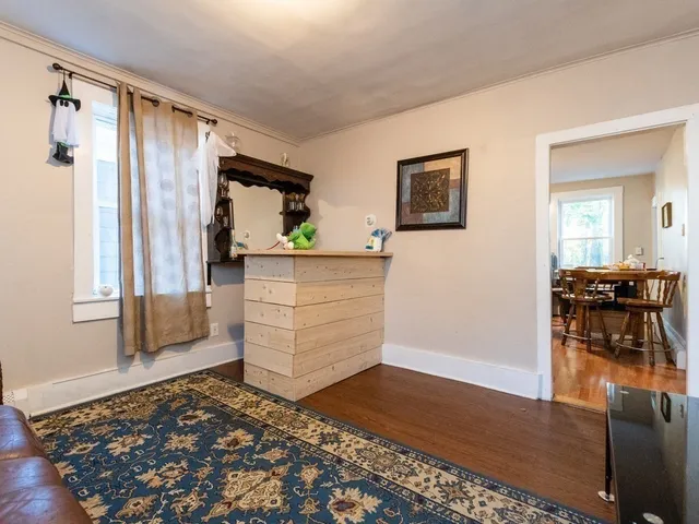 a view of a bedroom with furniture and window
