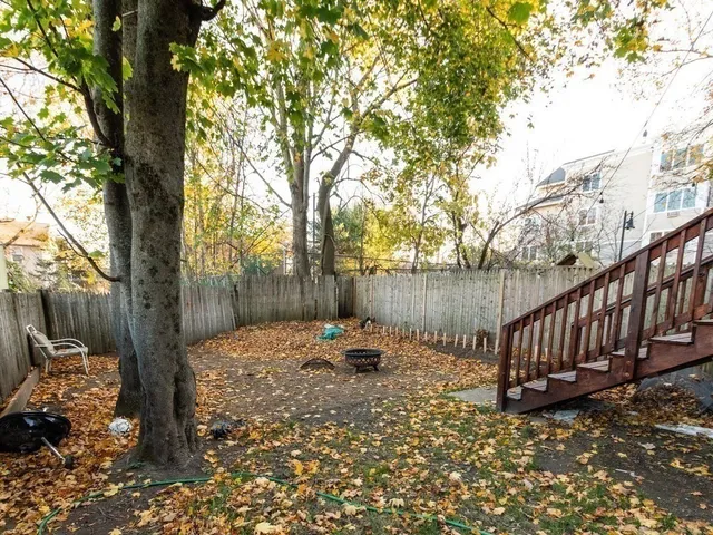 a backyard of a house with barbeque oven and outdoor seating