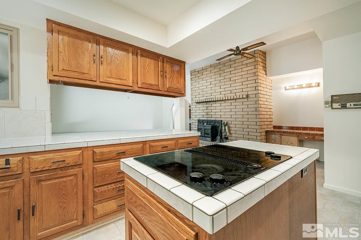 11040 Broken Hill Road Reno, NV 89511 - Photo 11 of 24 a kitchen with granite countertop a sink stove and cabinets