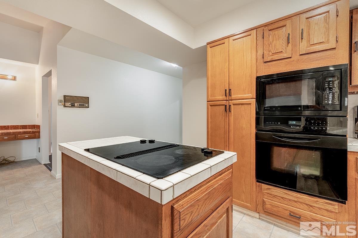 11040 Broken Hill Road Reno, NV 89511 - Photo 12 of 24 a kitchen with granite countertop a sink stove and refrigerator