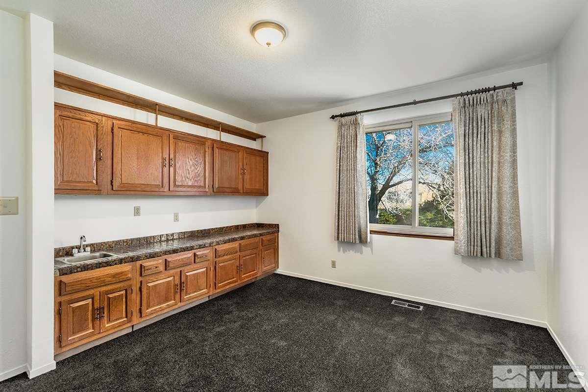 11040 Broken Hill Road Reno, NV 89511 - Photo 14 of 24 a kitchen with stainless steel appliances granite countertop a stove a sink and a microwave