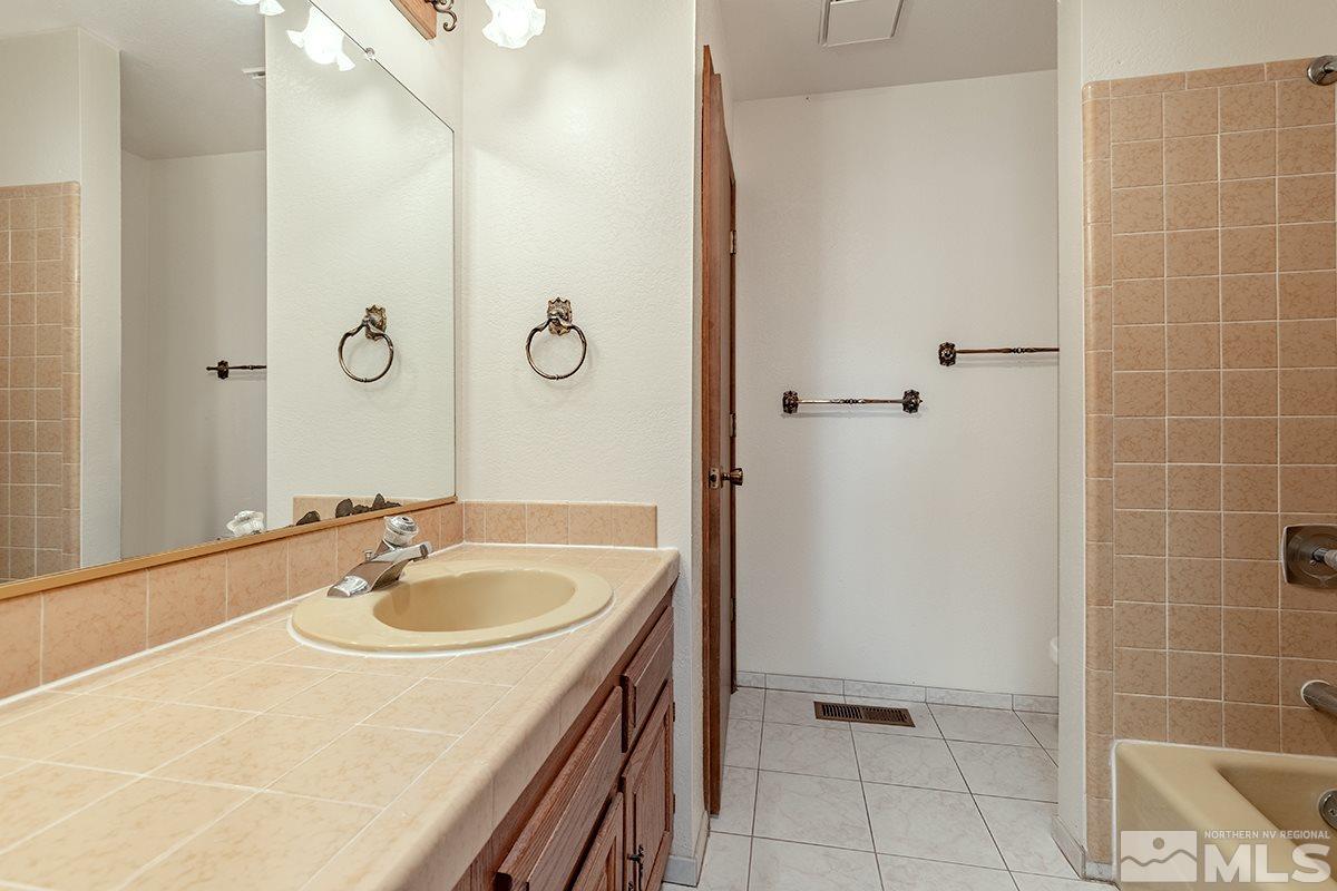11040 Broken Hill Road Reno, NV 89511 - Photo 20 of 24 a bathroom with a sink and a mirror