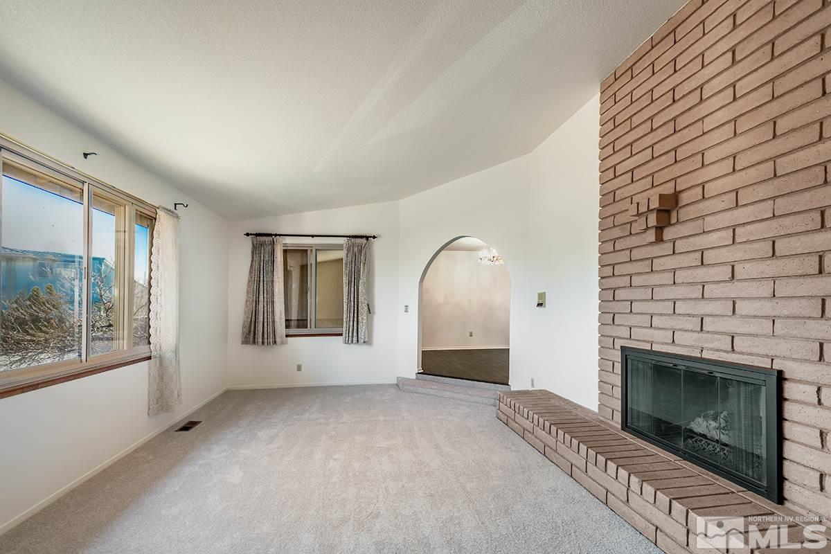 11040 Broken Hill Road Reno, NV 89511 - Photo 4 of 24 a view of empty room with a fireplace