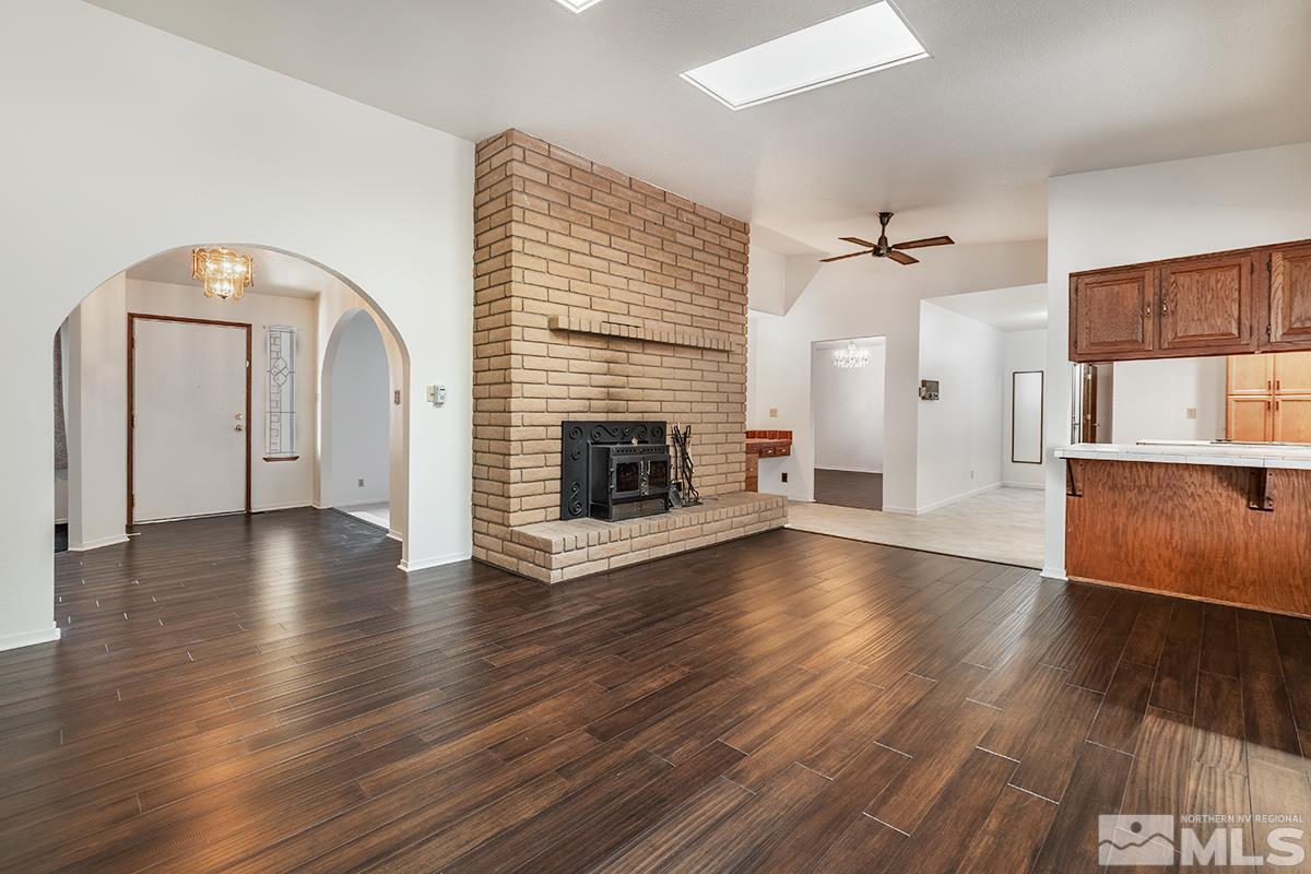 11040 Broken Hill Road Reno, NV 89511 - Photo 6 of 24 a view of a livingroom with wooden floor and a fireplace
