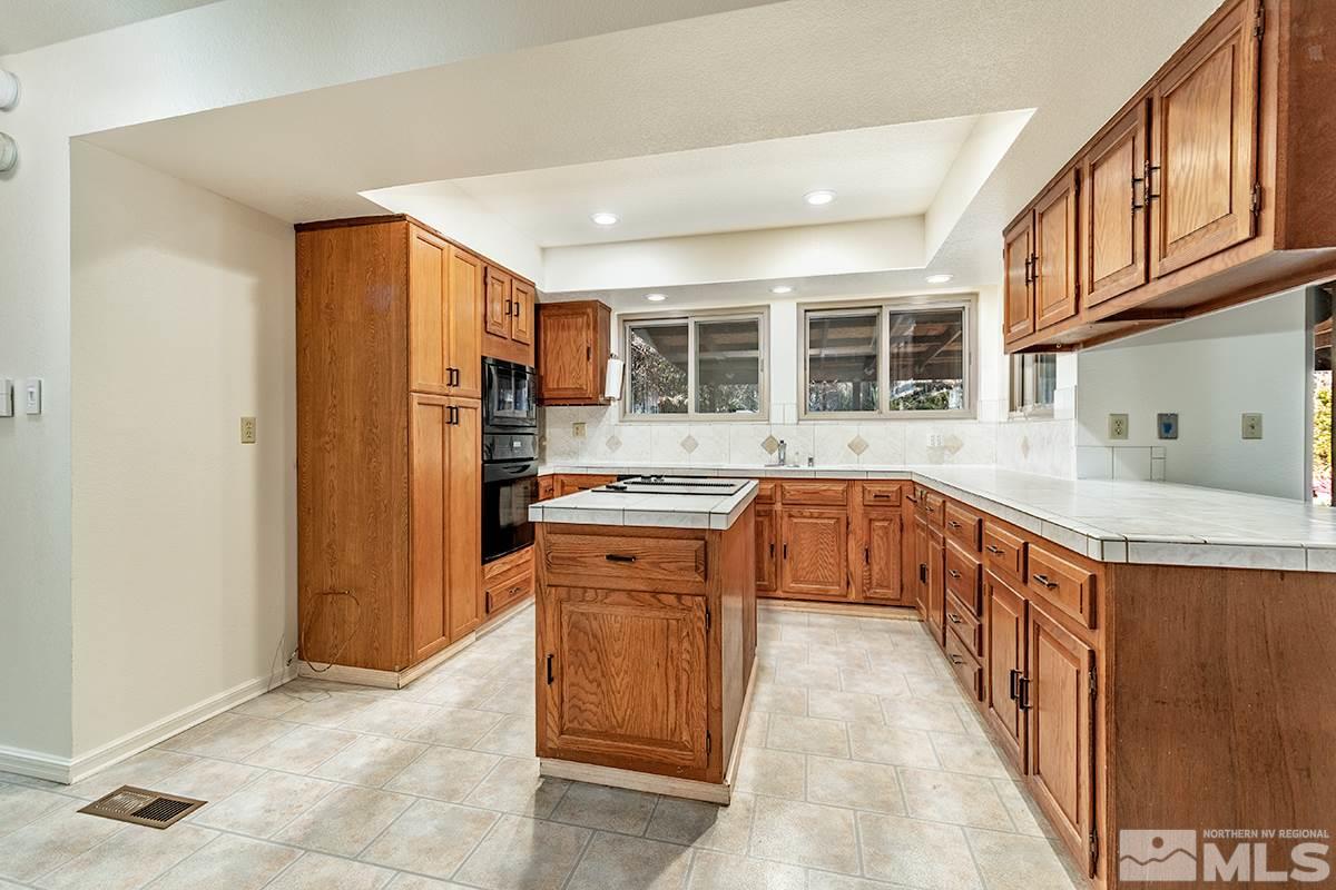 11040 Broken Hill Road Reno, NV 89511 - Photo 10 of 24 a kitchen with stainless steel appliances granite countertop a stove and a sink