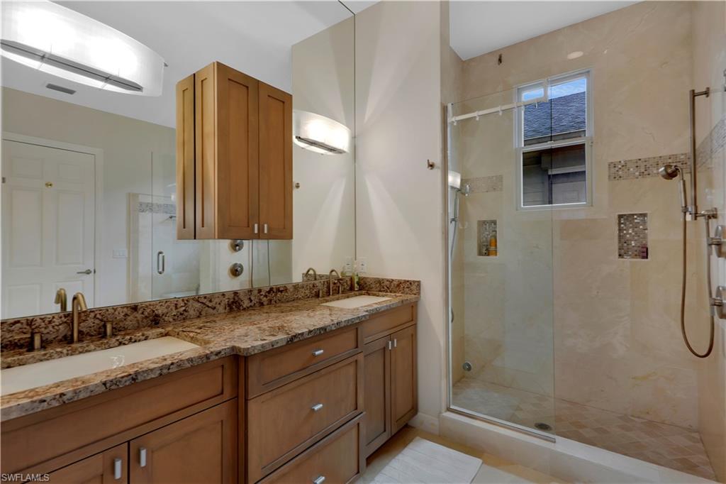 215 Auto Ranch Road Naples, FL 34114 - Photo 11 of 21 a bathroom with a granite countertop sink mirror and a shower