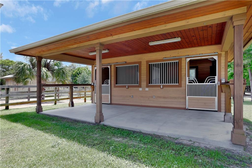 215 Auto Ranch Road Naples, FL 34114 - Photo 17 of 21 a view of a house with backyard and porch