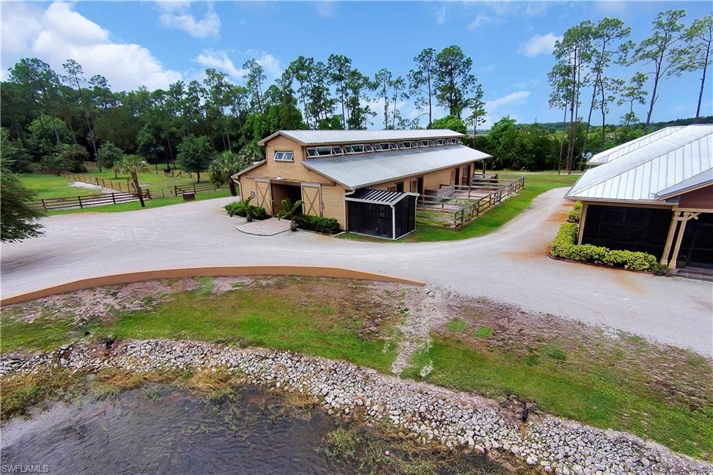 215 Auto Ranch Road Naples, FL 34114 - Photo 20 of 21 a aerial view of a house with a yard and a large tree