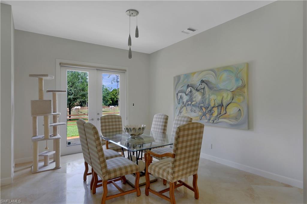 215 Auto Ranch Road Naples, FL 34114 - Photo 4 of 21 a view of a dining room with furniture window and outside view