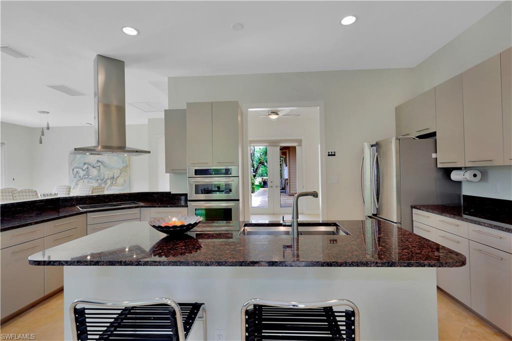 215 Auto Ranch Road Naples, FL 34114 - Photo 7 of 21 a kitchen with granite countertop a sink and white cabinets