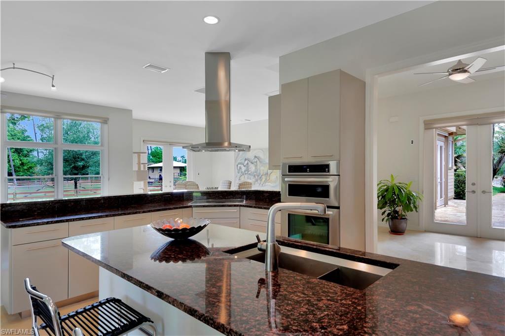 215 Auto Ranch Road Naples, FL 34114 - Photo 8 of 21 a kitchen with a sink a counter and cabinets