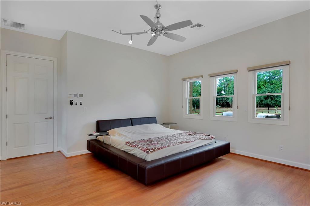 215 Auto Ranch Road Naples, FL 34114 - Photo 9 of 21 a bedroom with a bed and window