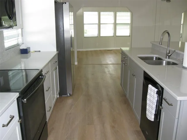 a kitchen with a sink and a stove top oven