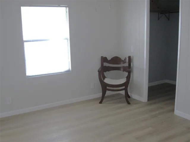 a room with a chair and a window