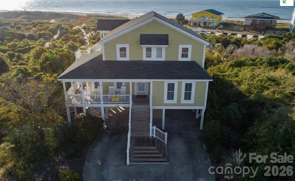 a aerial view of a house with a yard