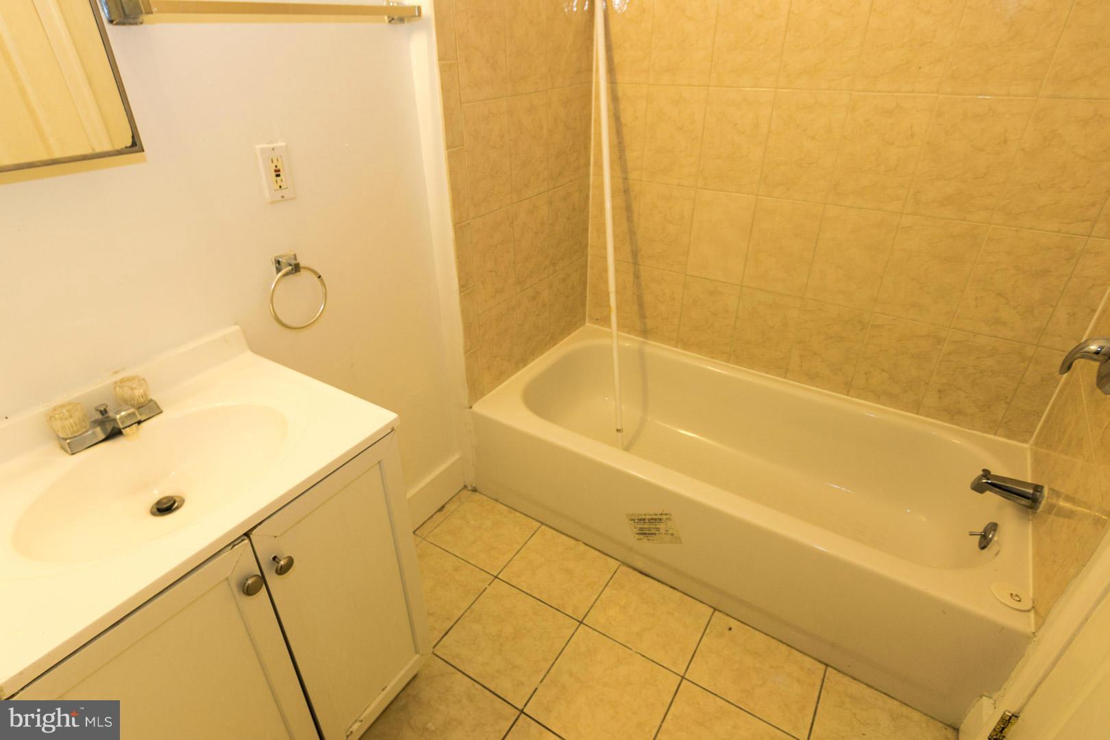 3607 Windsor Mill Road Baltimore, MD 21216 - Photo 11 of 25 a bathroom with a tub and shower