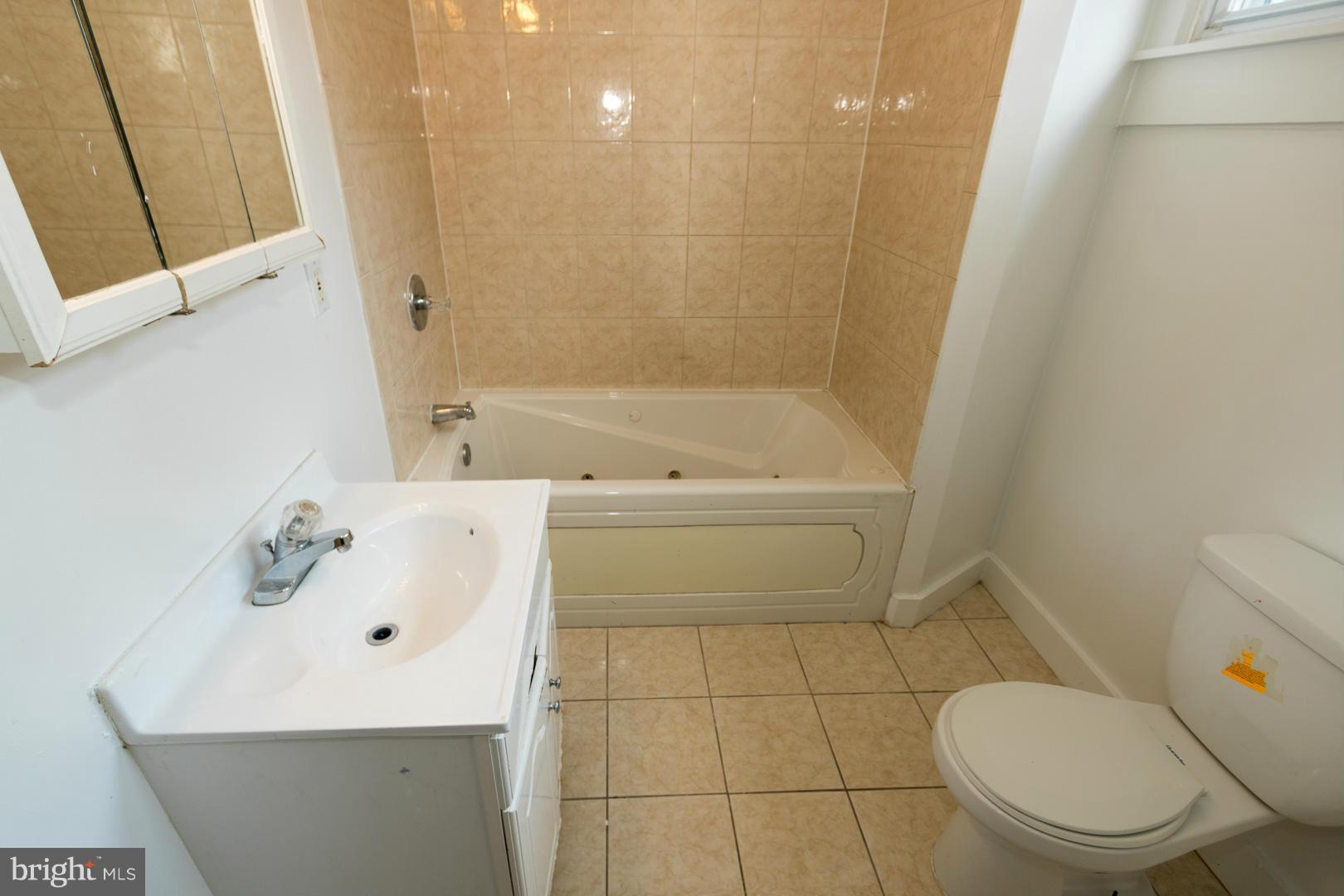 3607 Windsor Mill Road Baltimore, MD 21216 - Photo 16 of 25 a bathroom with a sink a toilet and shower