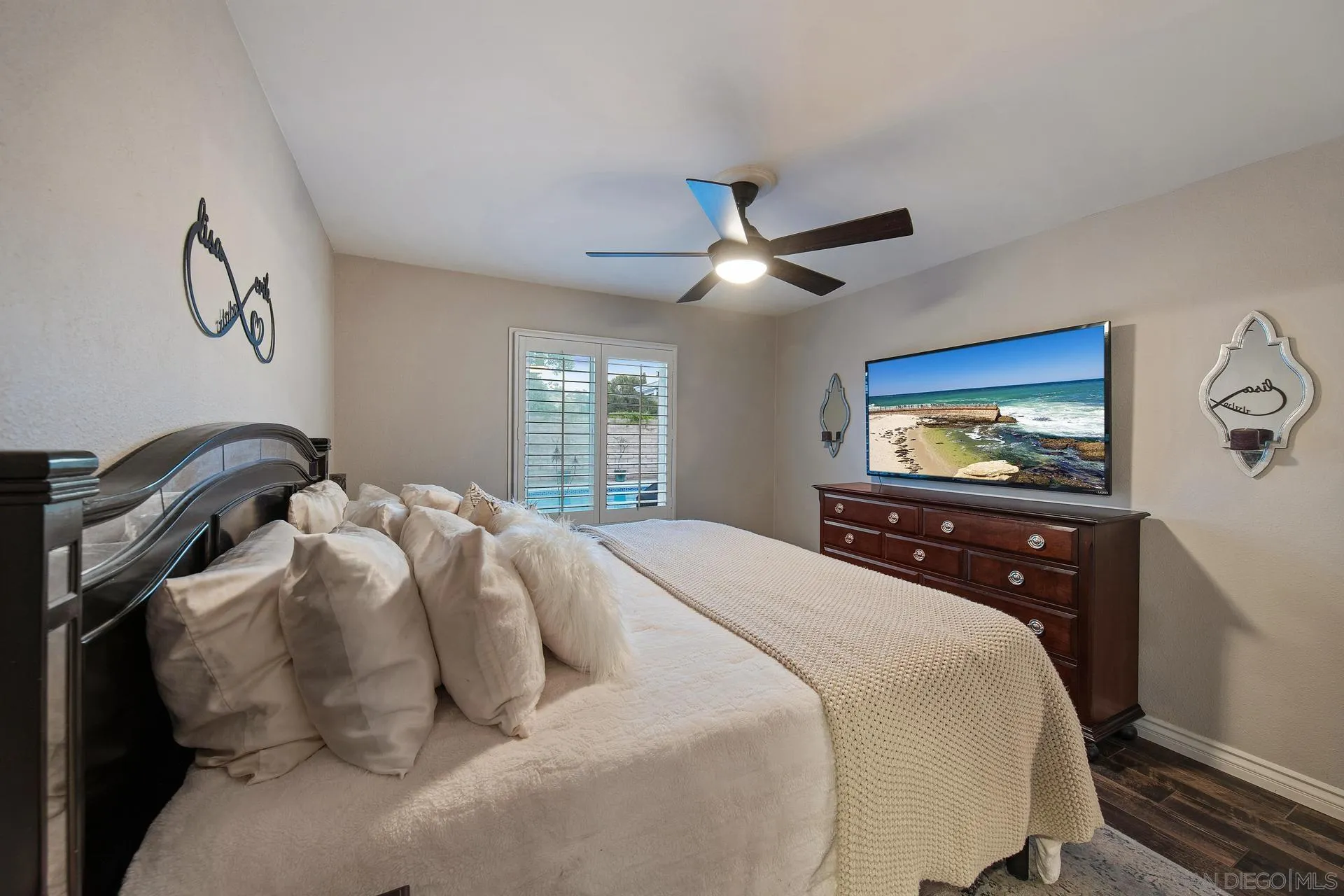 14161 Halper Road Poway, CA 92064 - Photo 39 of 64 a bedroom with a bed and a chandelier