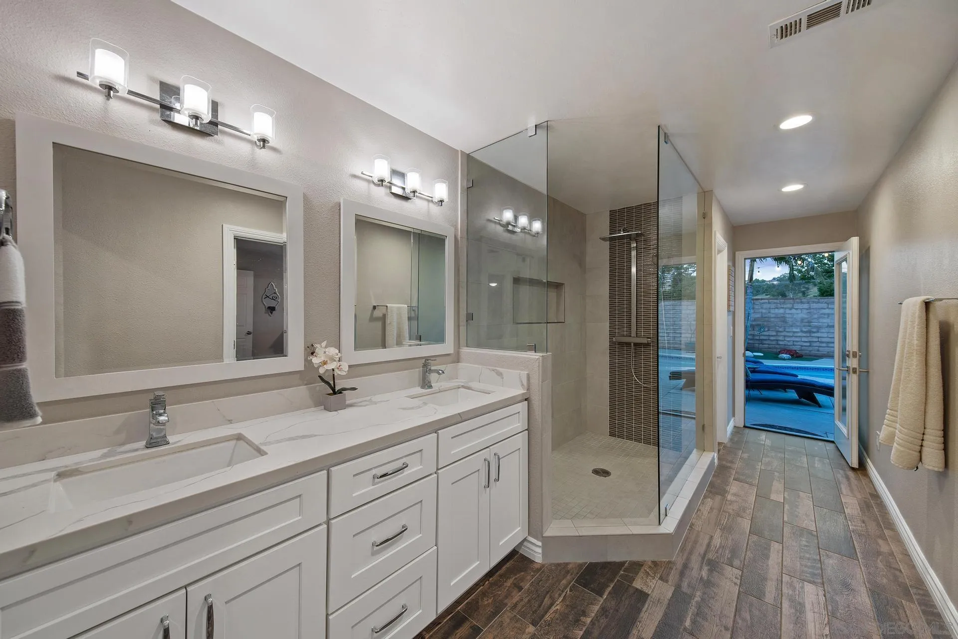 14161 Halper Road Poway, CA 92064 - Photo 44 of 64 a spacious bathroom with a double vanity sink a mirror and shower