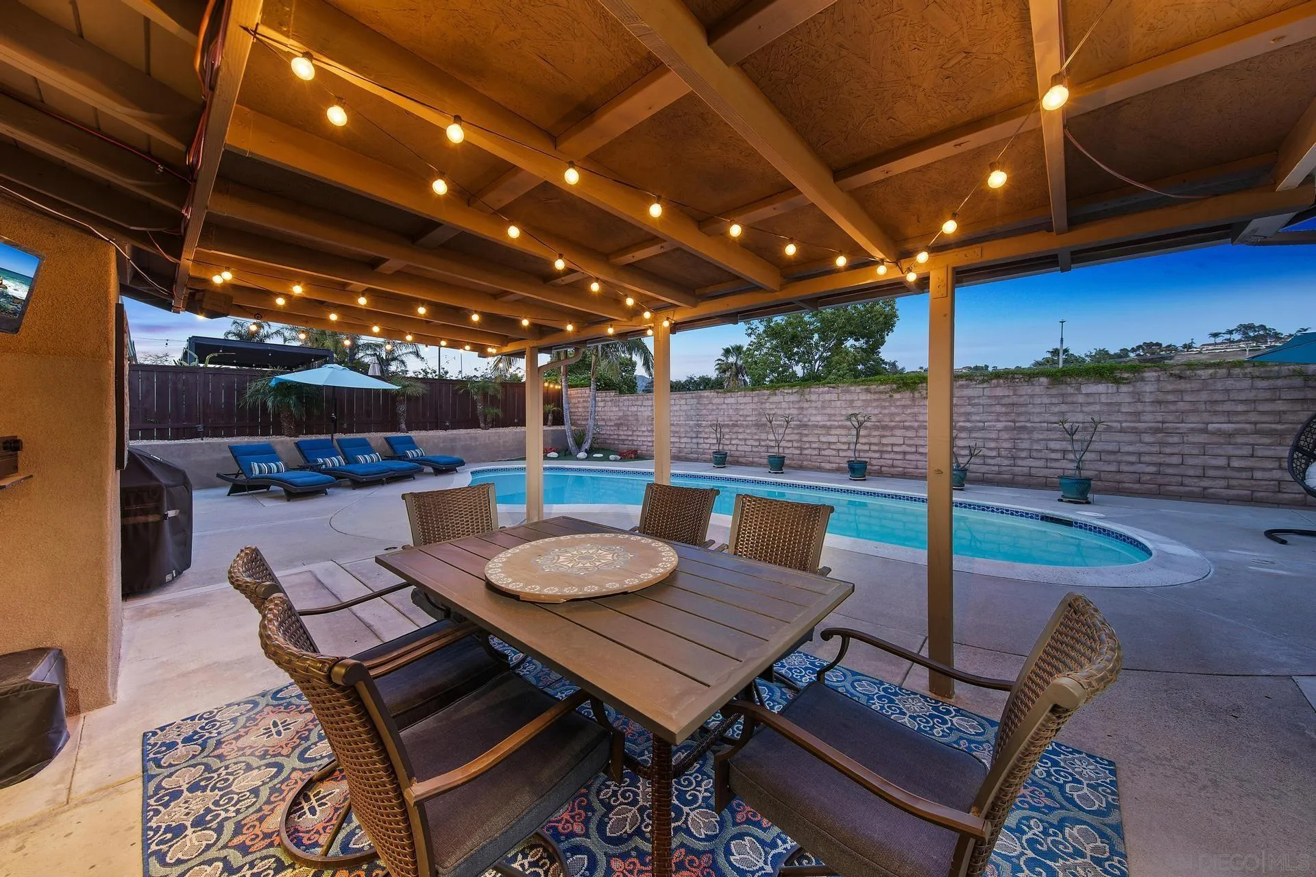 14161 Halper Road Poway, CA 92064 - Photo 7 of 64 a view of a patio with table and chairs with wooden floor and fence