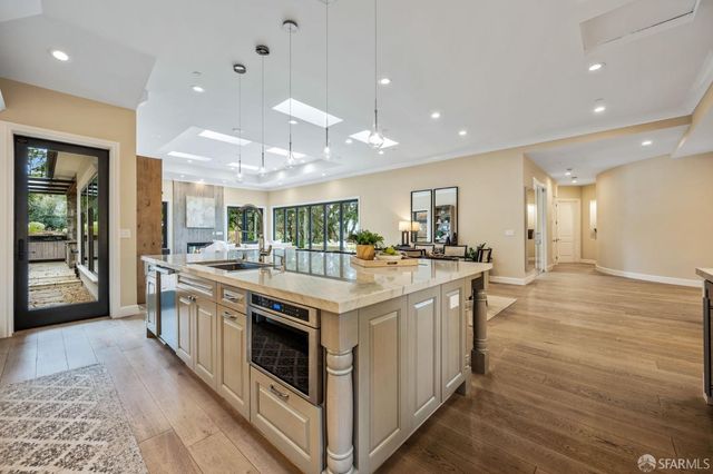 a large kitchen with stainless steel appliances granite countertop a large counter top and a stove