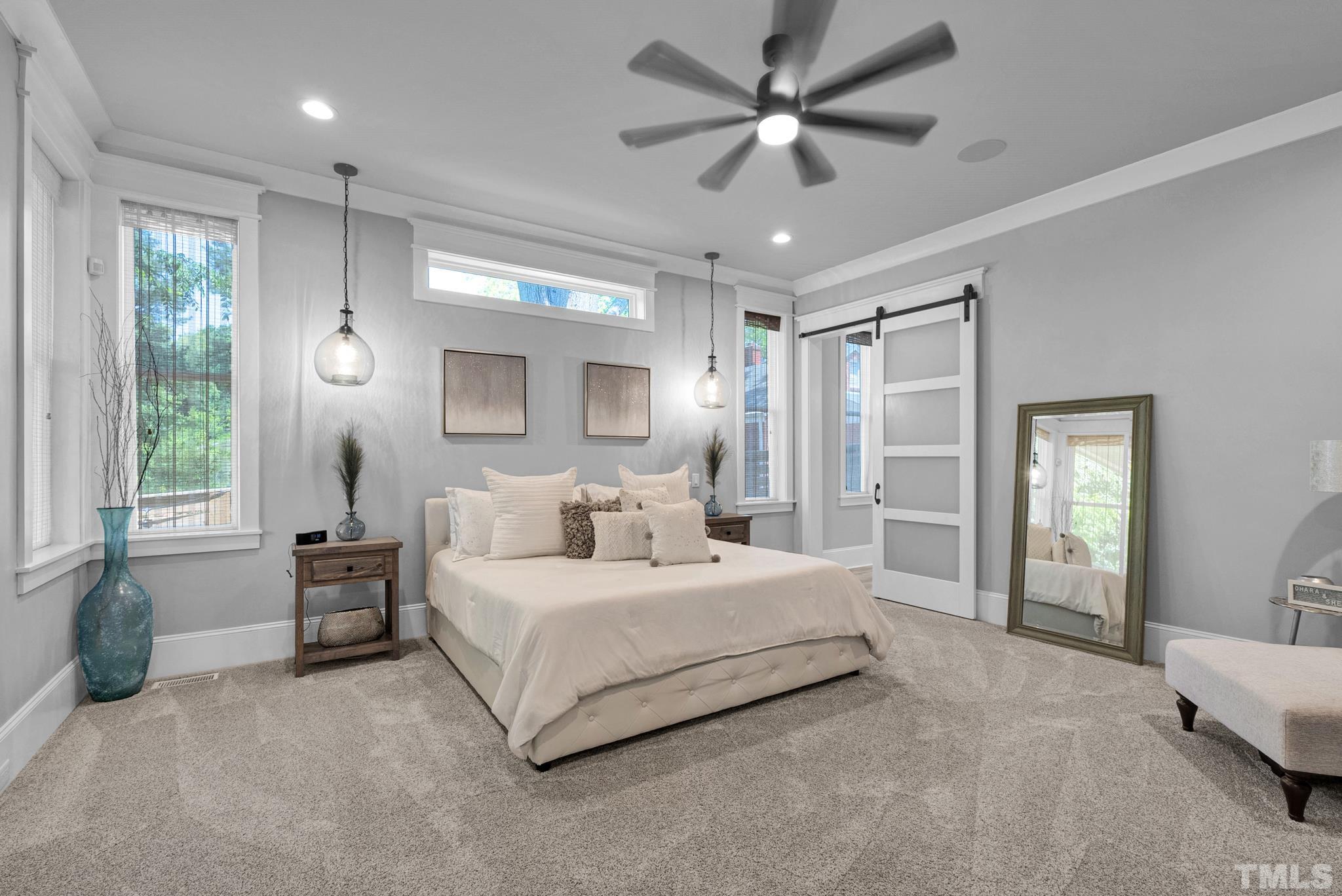 903 North State Street Raleigh, NC 27604 - Photo 27 of 56 a spacious bedroom with a large bed and a chandelier