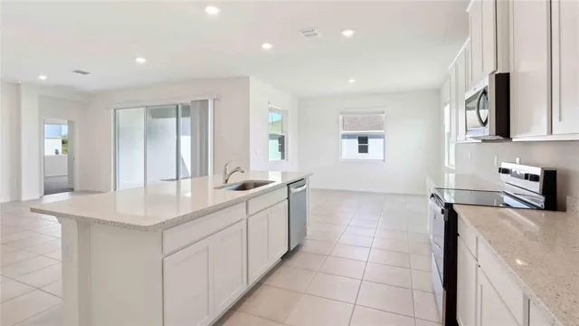 a kitchen with a sink and a stove top oven