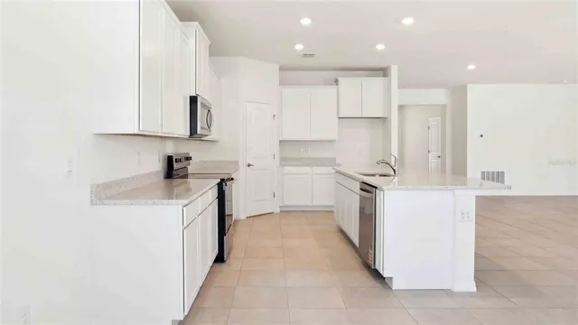 a kitchen with stainless steel appliances granite countertop a sink and a stove