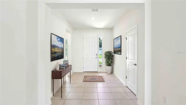 a hallway with a computer on a desk and chair