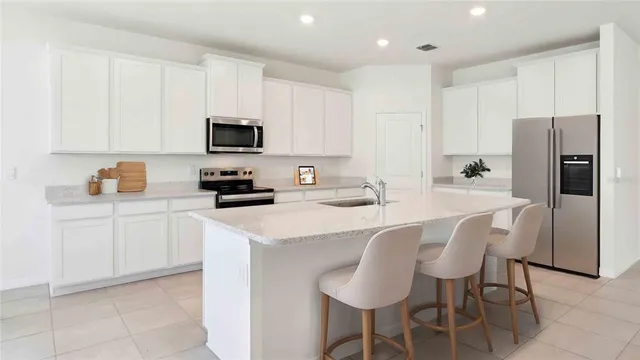 a kitchen with a sink cabinets and refrigerator