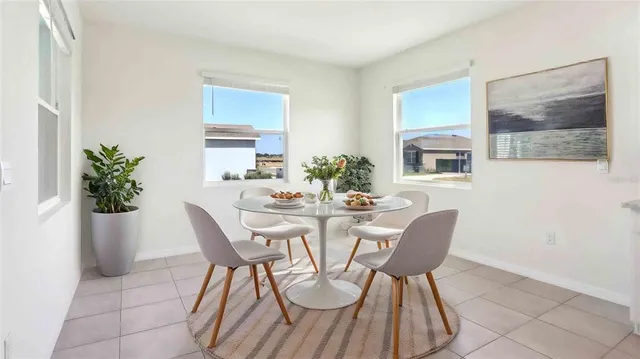 a view of a dining room with furniture and chandelier