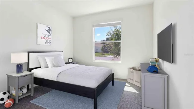 a bedroom with a bed a couch and a window