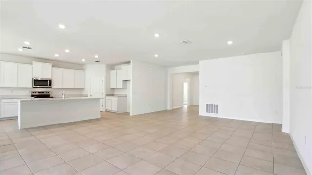 a view of kitchen with granite countertop cabinets and white appliances
