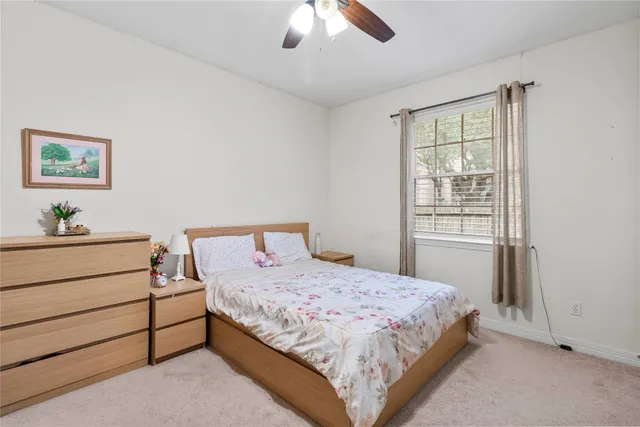 a bedroom with a bed lamp and window