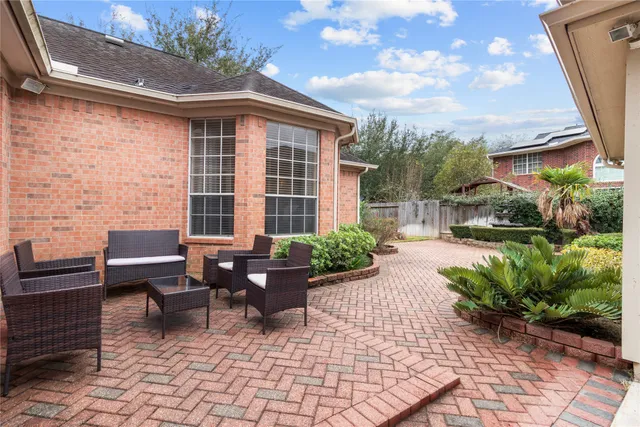 a view of a patio with a table and chairs