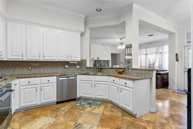 a large kitchen with granite countertop a stove and a sink