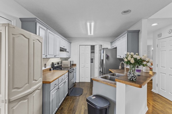 500 Berry Circle Springfield, TN 37172 - Photo 10 of 27 a kitchen with stainless steel appliances a sink stove refrigerator and cabinets