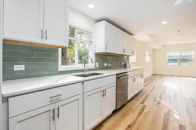 a kitchen with granite countertop white cabinets and white appliances