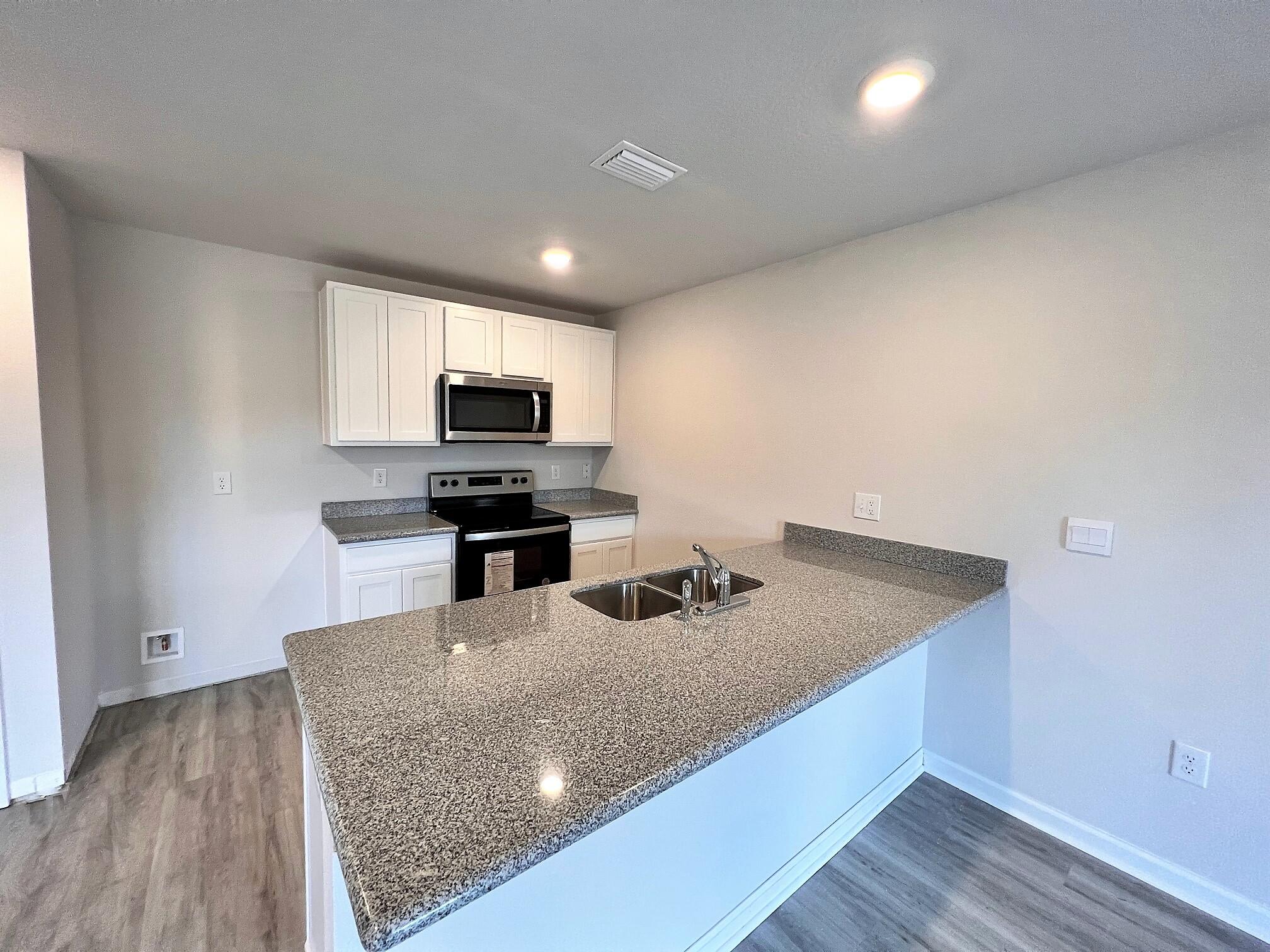 3017 Jane Lane Crestview, FL 32539 - Photo 3 of 17 a kitchen with a sink microwave and cabinets