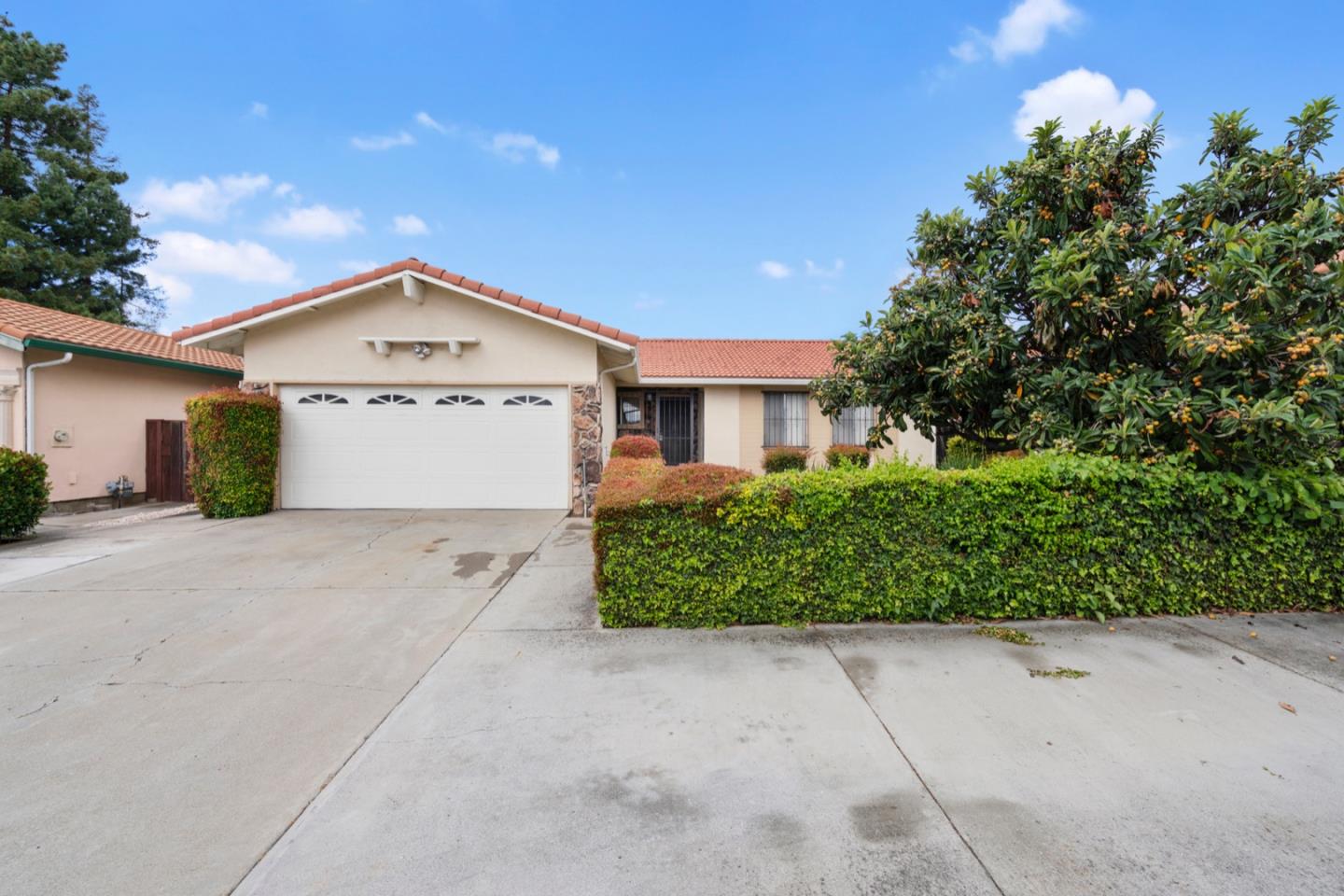 2885 Berryessa Road San Jose, CA 95132 - Photo 1 of 21 a front view of a house with a yard and garage